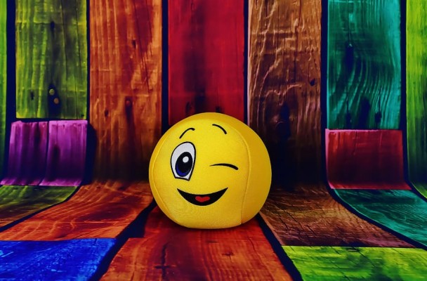 Yellow Emoji On Multicolored Wood Parquet Graphic Wallpaper, - 910x598  Wallpaper 