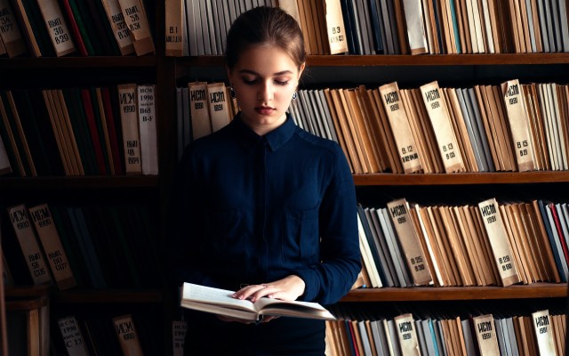 woman reading a book in library